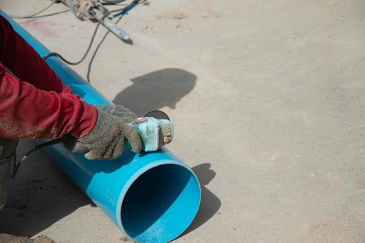 Workers are using PVC pipe cutters. photo