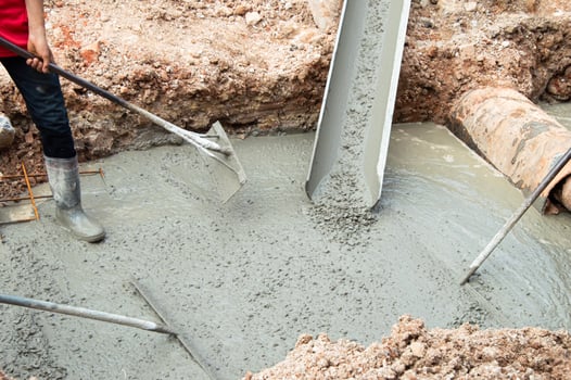 Workers are pouring cement on the construction site. photo