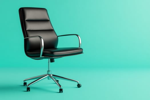 Modern black office chair, teal background, workspace photo