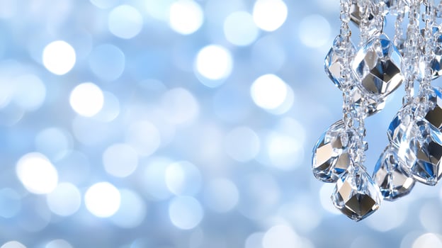 Elegant crystal chandelier reflecting light against a soft blue background photo