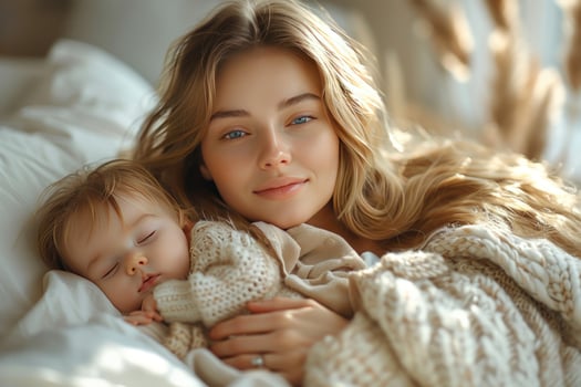 Mother and baby daughter sleeping together in a cozy embrace photo