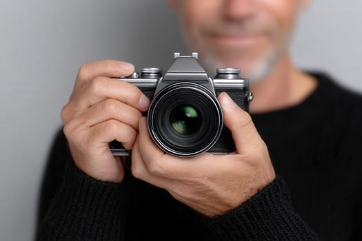 Holding a vintage film camera ready to take a picture photo
