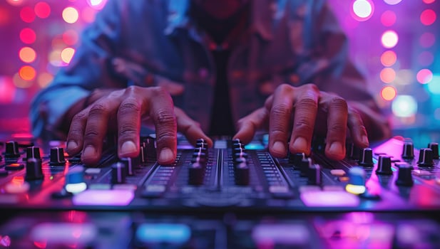 Dj mixing music on soundboard at nightclub event photo