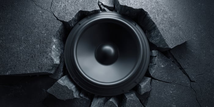 The speaker bursting through the concrete wall in a dramatic urban setting photo