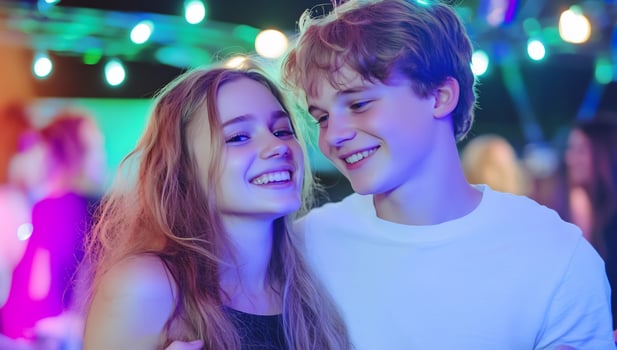 Teen couple smiles, night market, bokeh lights, romantic photo