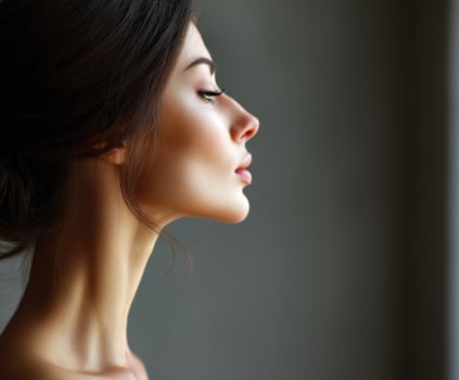 Beautiful woman with long hair and makeup looking up photo