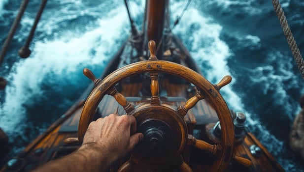 Sailing navigation on the open ocean aboard a classic wooden ship photo