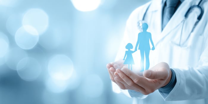 The doctor holding a holographic image of a family in his hands. photo