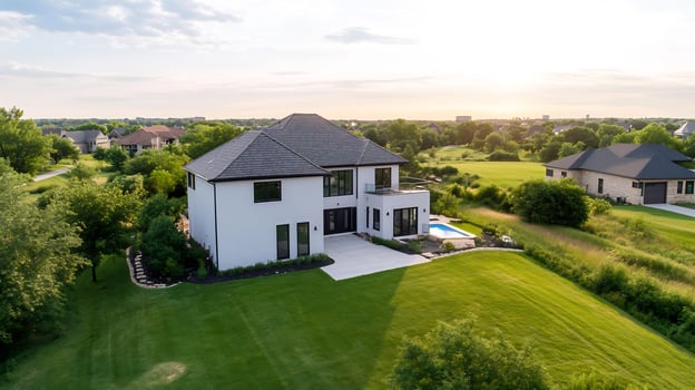 Modern house, sunset view, suburban landscape, aerial shot real estate listing photo