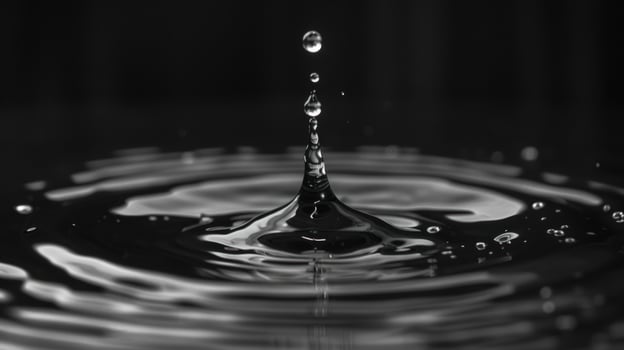 Water drop impact creating ripples in a pool of liquid macro photography photo