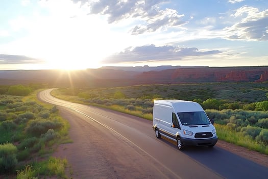 Van drives desert highway sunset photo