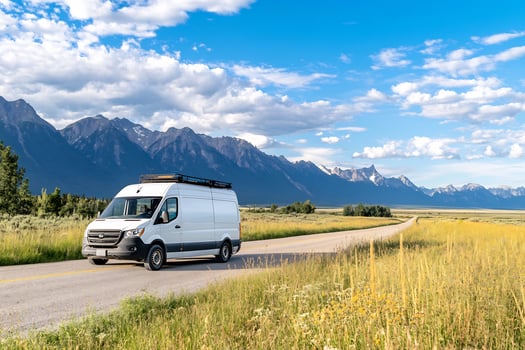 White van drives scenic mountain road photo