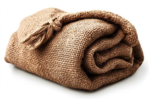 Textured brown fabric bundle with tied knot on plain background photo
