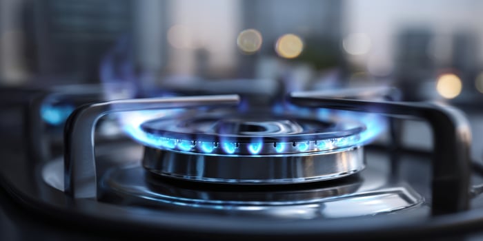 The gas flame shining brightly on a modern kitchen stove. photo