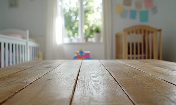 Wooden table in nursery, toys blurred background, product display photo