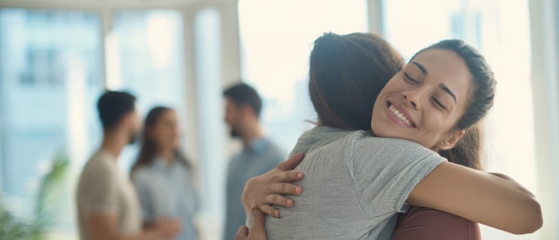 The heartwarming embrace of friends celebrating their connection in a cozy setting. photo