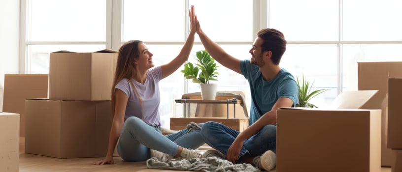 The joyful couple celebrating their new home together amidst unpacked boxes. photo