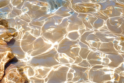 Sunlit shallow water, beach texture, background photo
