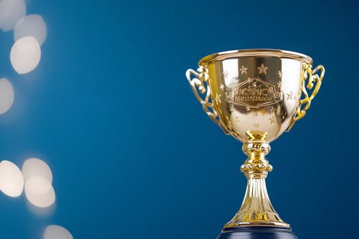 Gold trophy victory award, blue background photo