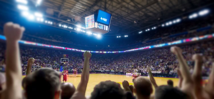 Excited fans cheering at basketball game photo