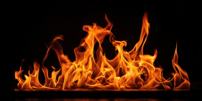 The Dancing Flames Emanating a Mesmerizing Glow in the Darkness. photo