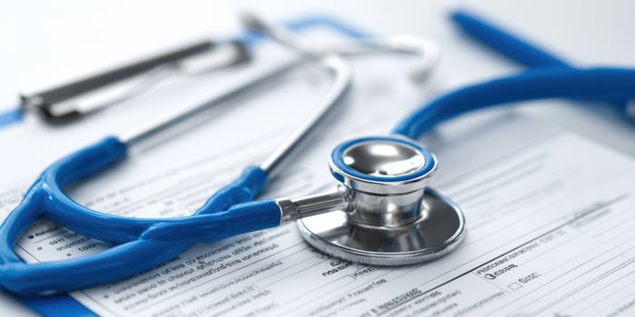 The stethoscope and medical paperwork on a health care desk setting. photo