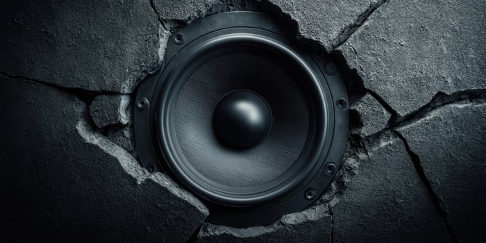 The speaker emerging from a cracked wall for a striking audio experience. photo