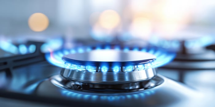 The vibrant blue flame of a kitchen gas burner in action photo