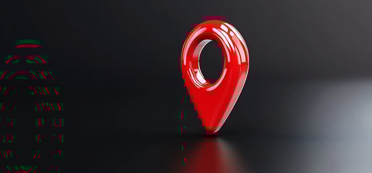 Red location pin on dark surface, digital map photo
