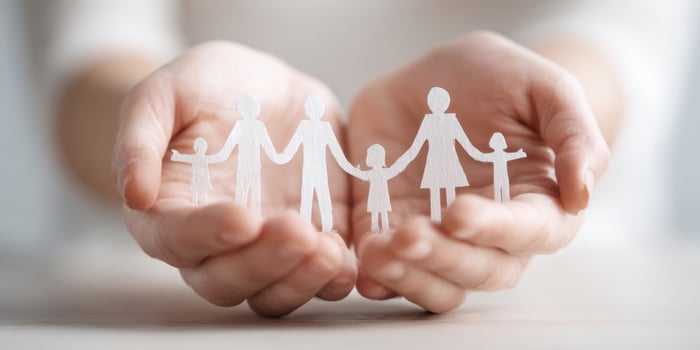 The family displayed in hands symbolizing love and unity photo