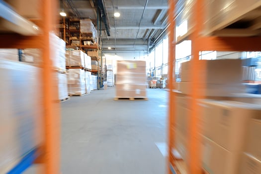A blurry image of a warehouse with boxes and shelves photo