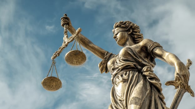 The Symbol of Justice Holding Scales Against a Blue Sky photo