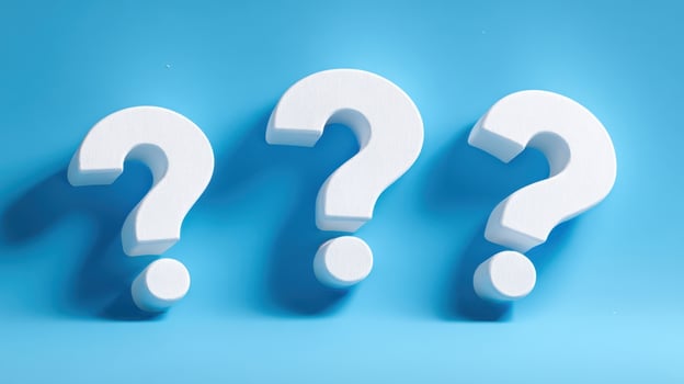 The bold question marks inviting curiosity on a vibrant blue background. photo