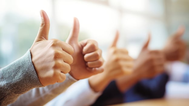 The hands show enthusiastic thumbs up for teamwork and success. photo