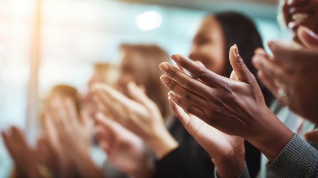 The hands of an engaged audience demonstrating enthusiastic applause and appreciation. photo