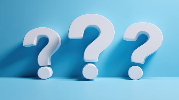 The Three Question Marks Against a Blue Background Representing Inquiry and Curiosity photo