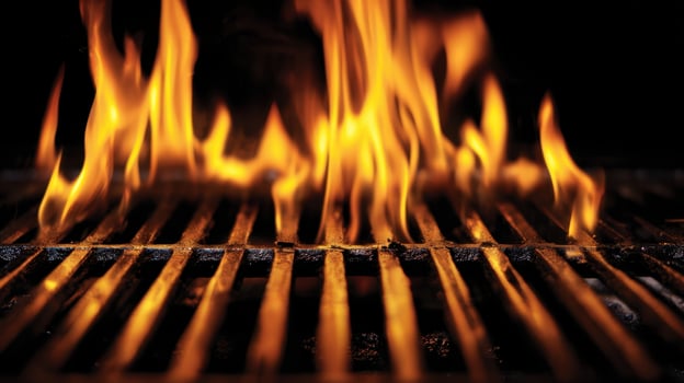 The flames dancing on a grill create a vibrant cooking atmosphere. photo