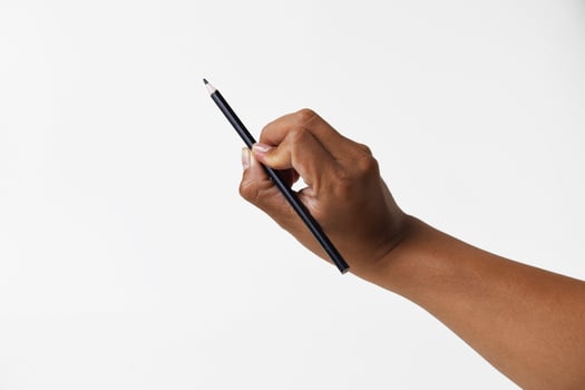Close up of Asian hand holding a pencil on white background photo