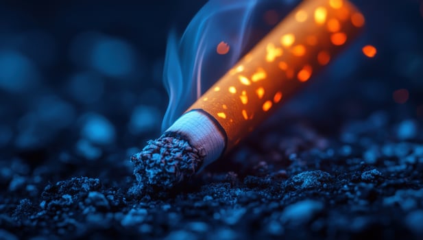 Burning cigarette with smoke on dark ground represents health risks photo