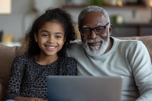 Intergenerational connection african american girl and senior man using computer photo