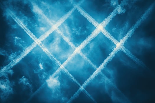 Crisscross vapor trails in blue sky aviation atmosphere photo