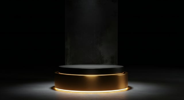 Sleek black pedestal with gold trim and illuminated base against a dark textured background photo
