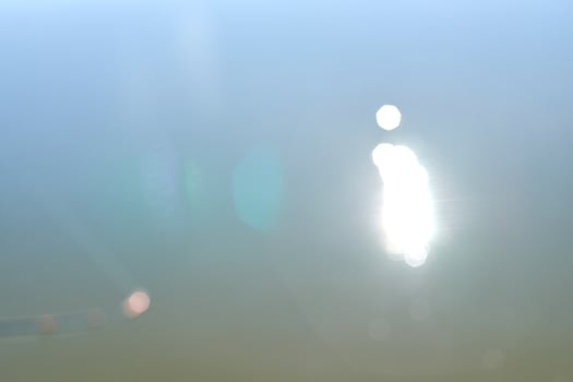 Abstract sunlight reflection on water surface with soft pastel blue and green bokeh effect. photo