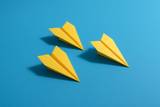 Two yellow airplanes flying ahead leading the last yellow airplane to symbolize shared leadership photo