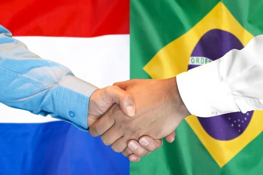 handshake on Brazil and Netherlands flag background. photo
