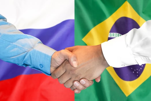 handshake on Brazil and Russia flag background. photo