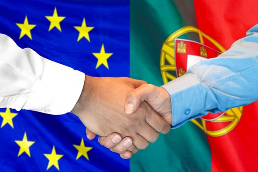 handshake on Portugal and European Union flag background. photo