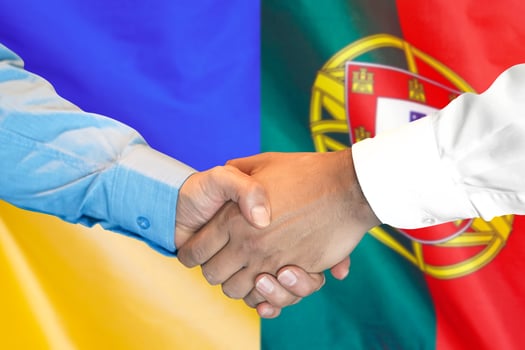 Handshake on Portugal and Ukraine flag background photo