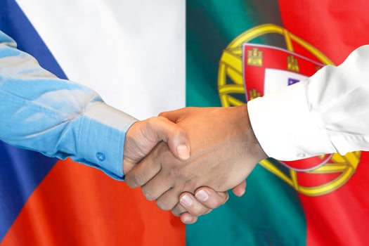 handshake on Portugal and Czech Republic flag background. photo