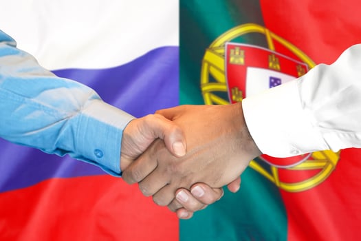handshake on Portugal and Russia flag background. photo
